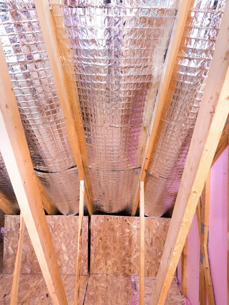 Radiant barrier installed in attic to reduce heat buildup and improve energy efficiency